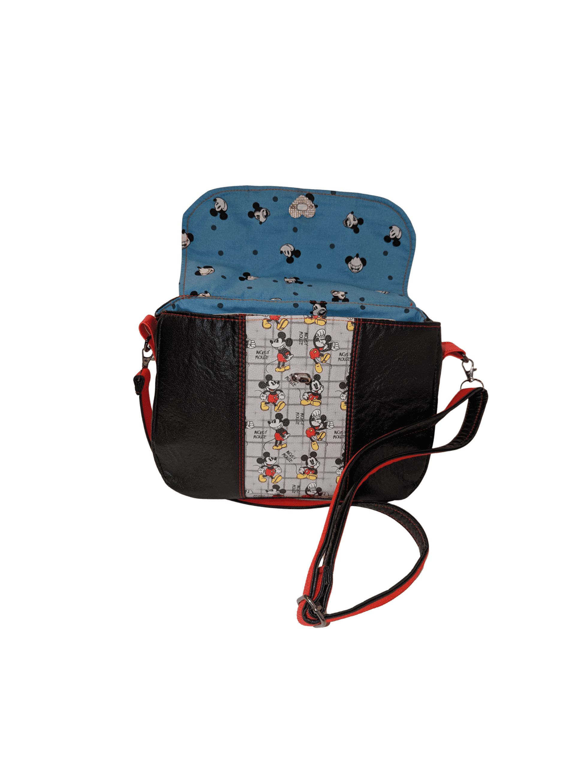 Printed crossbody handbag with flap open showing blue lining