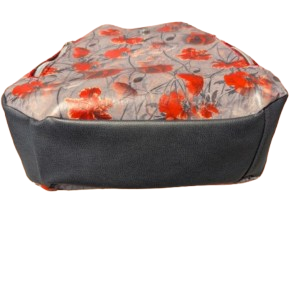 Bottom panel of structured floral hobo handbag with faux leather base.