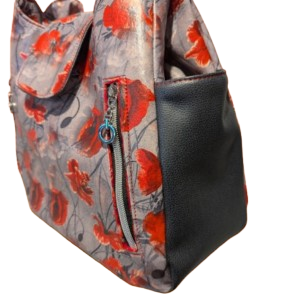 Side zipper detail on structured floral hobo handbag.