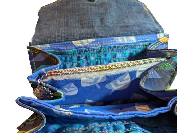 Expanded accordion wallet with multiple storage sections and zipper compartment.