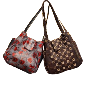 Two structured hobo handbags featuring floral and woven-inspired exterior styling.