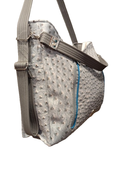 gray convertible crossbody bag with turquoise zipper accents