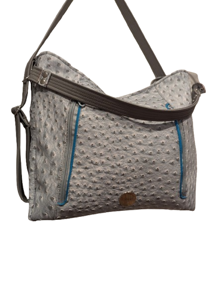 Handmade convertible handbag with angled zipper pockets and adjustable strap