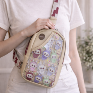 beige character sling bag crossbody purse worn on model front view
