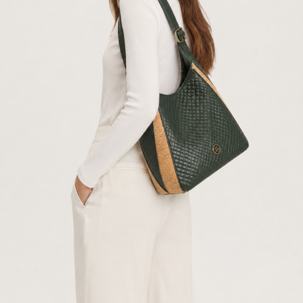 Forest green handmade hobo bag with cork accents worn over the shoulder