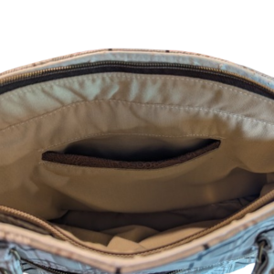 Interior slip pocket inside neutral plaid handbag with organized storage compartments.