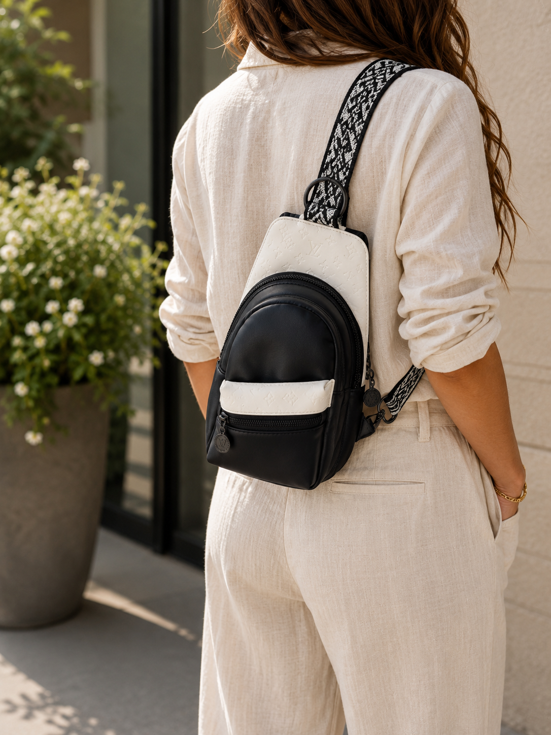 Front view of a custom handmade mini sling bag with four pockets and premium faux leather.