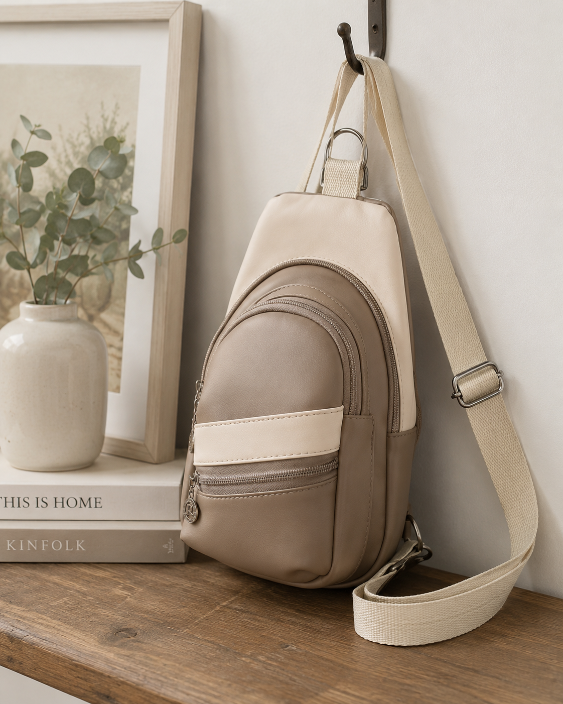 Custom handmade mini sling bag displayed in a neutral home setting.