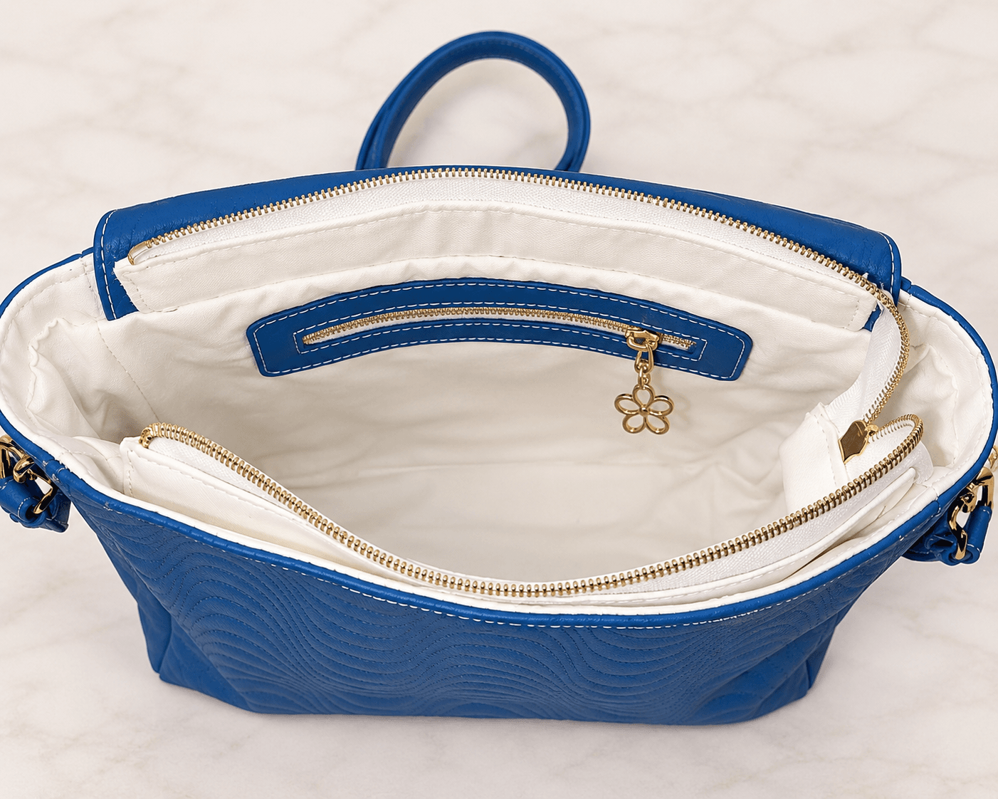 White lined blue crossbody bag interior with zipper pocket