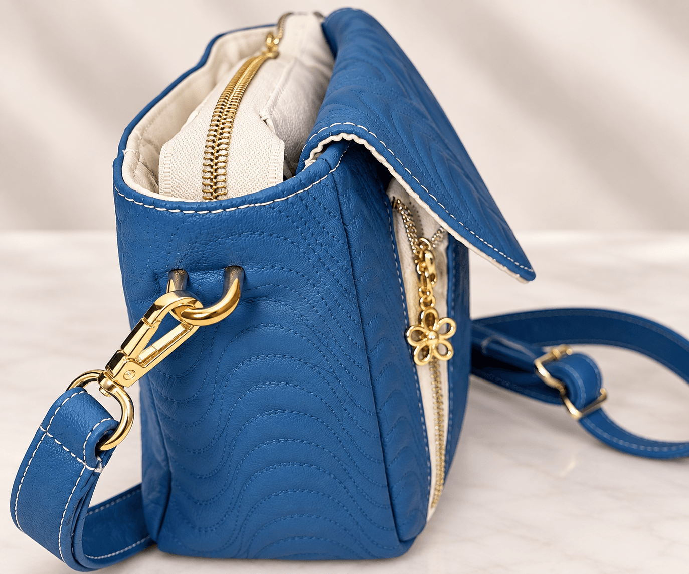 blue-quilted-crossbody-bag-side-hardware.jpg