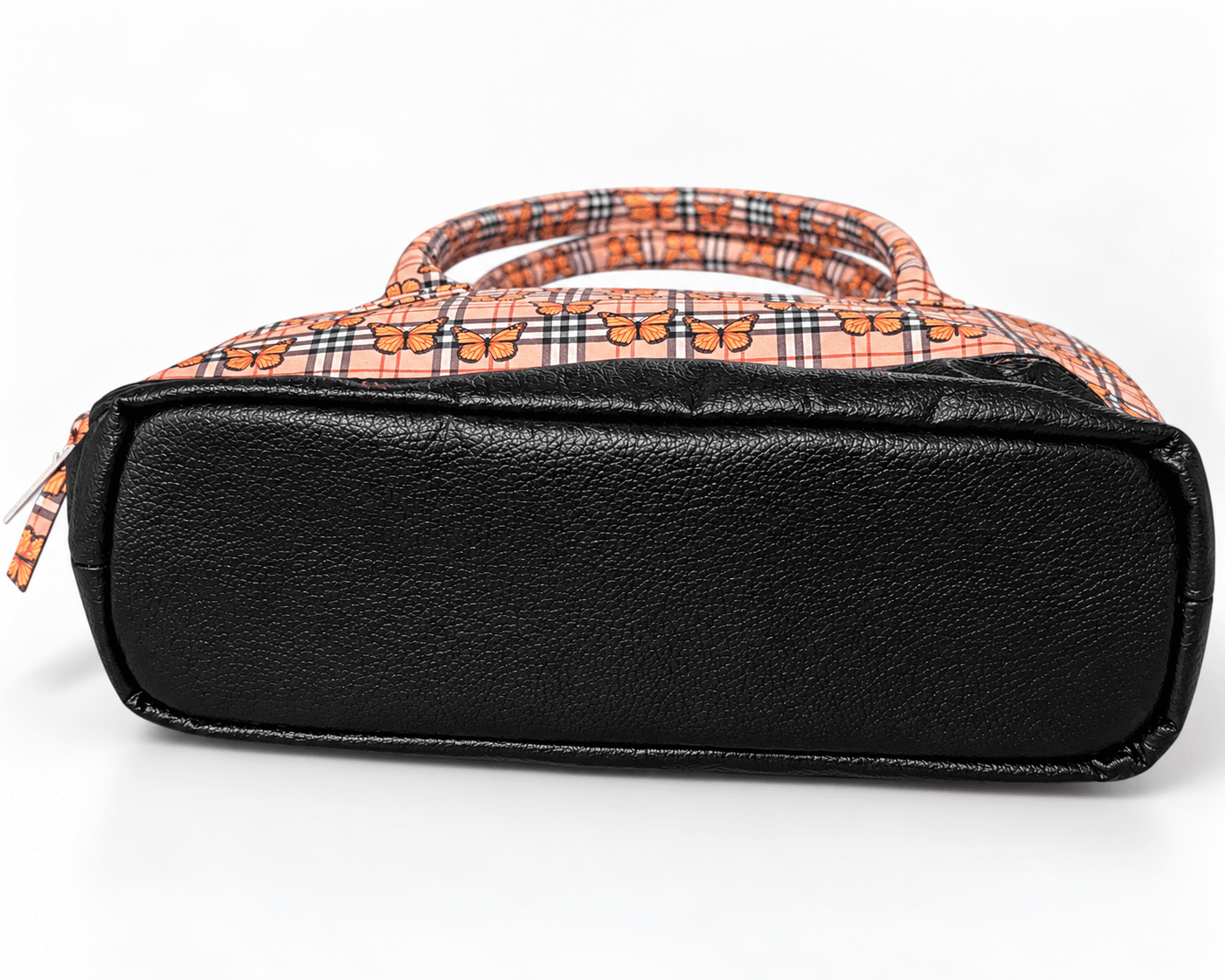 Bottom view of butterfly plaid handbag showing its rectangular black faux leather base and finished seams.