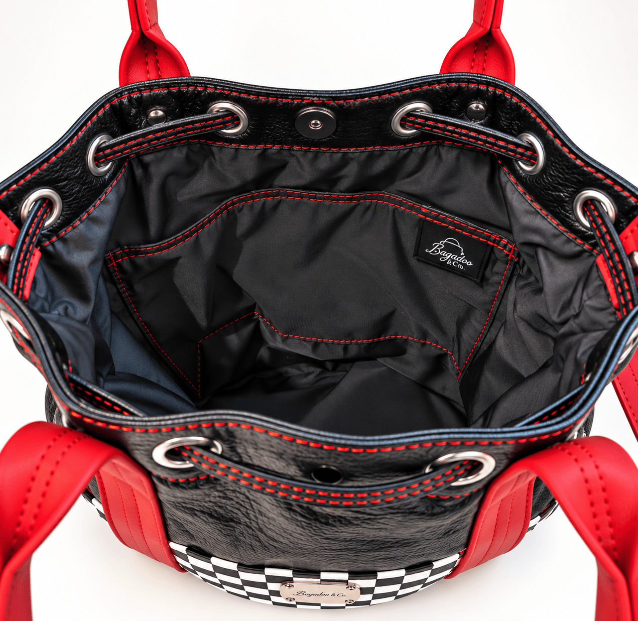 Black lined bucket handbag interior with divided slip pocket and red contrast stitching