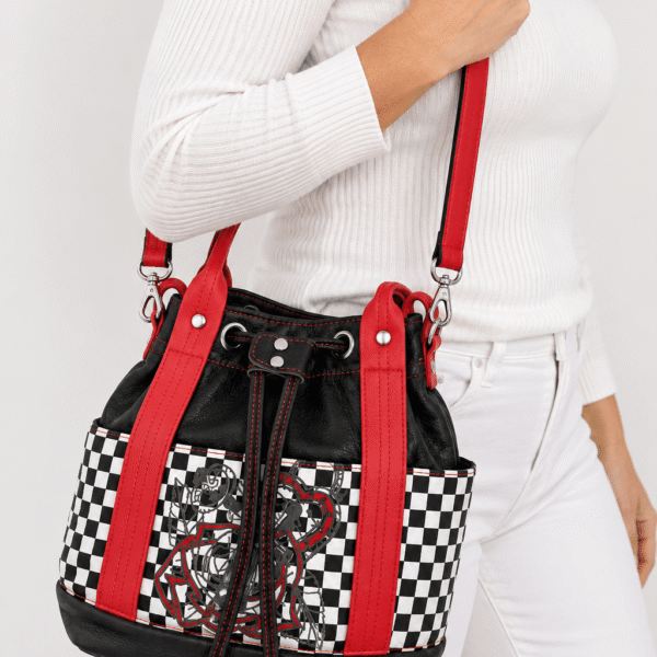 Model wearing a red, black and white checkered handmade bucket handbag with crossbody strap
