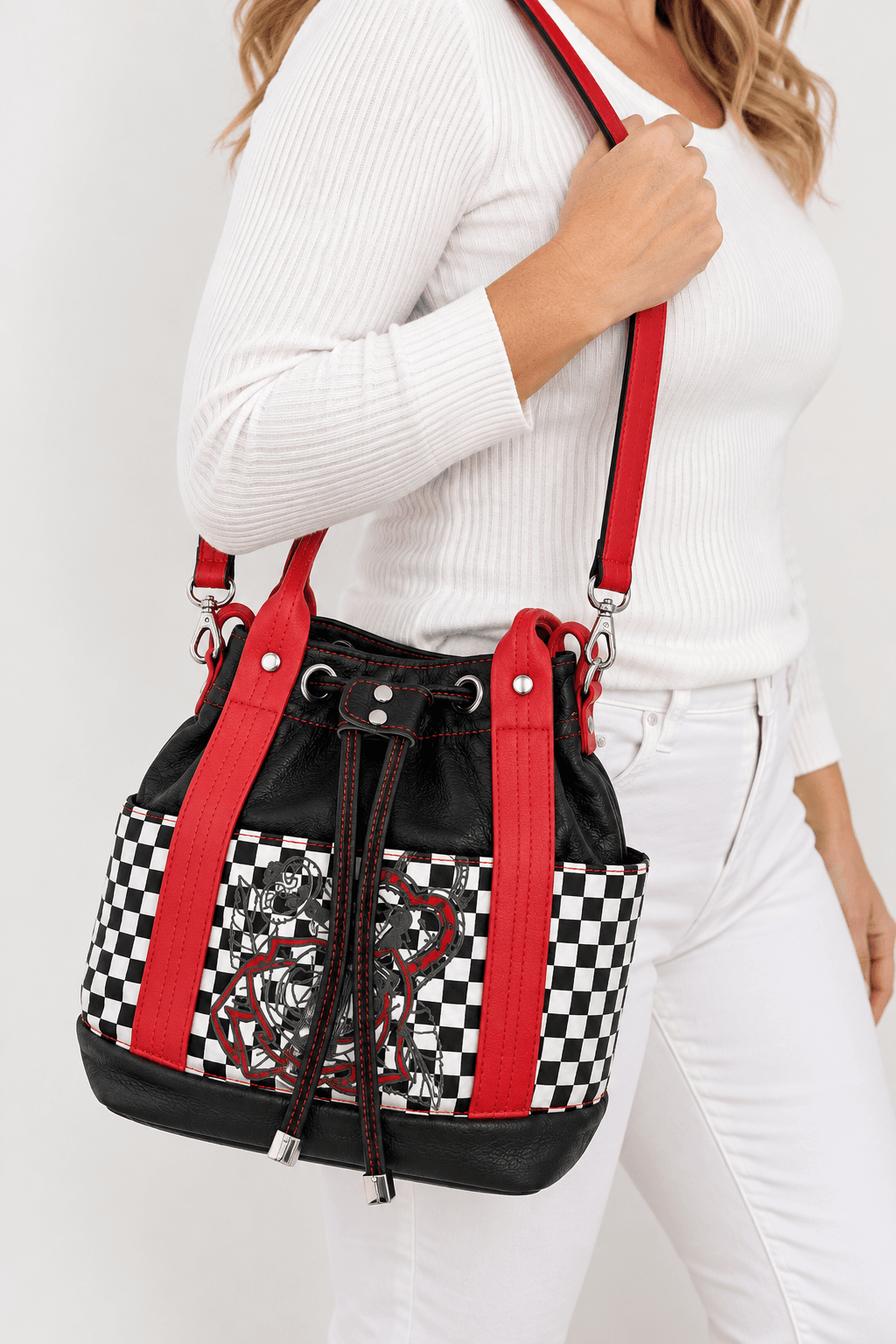 Model wearing a red, black and white checkered handmade bucket handbag with crossbody strap