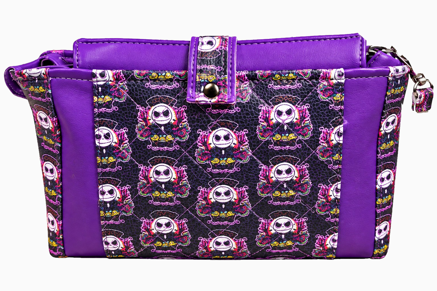 Back of purple and black skull-print wristlet with diamond quilting, purple faux leather panels, and decorative center tab.